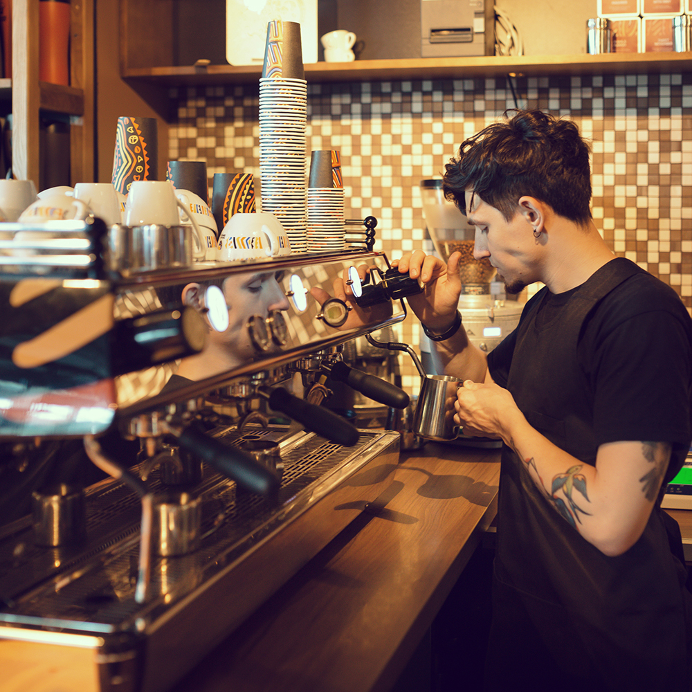 Barista making coffee in a coffee shop.
