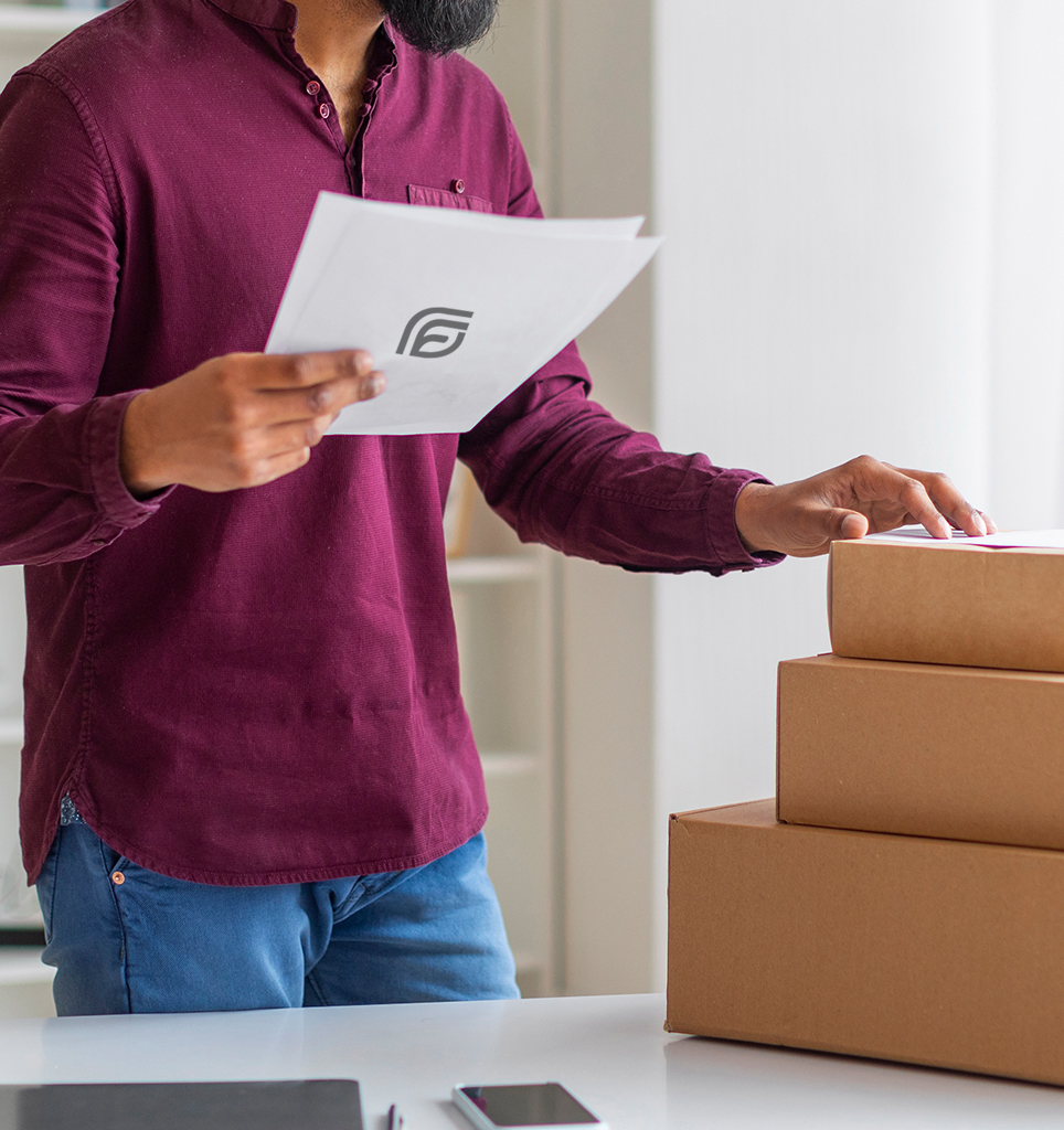 Professional purchaser reviewing papers and packages