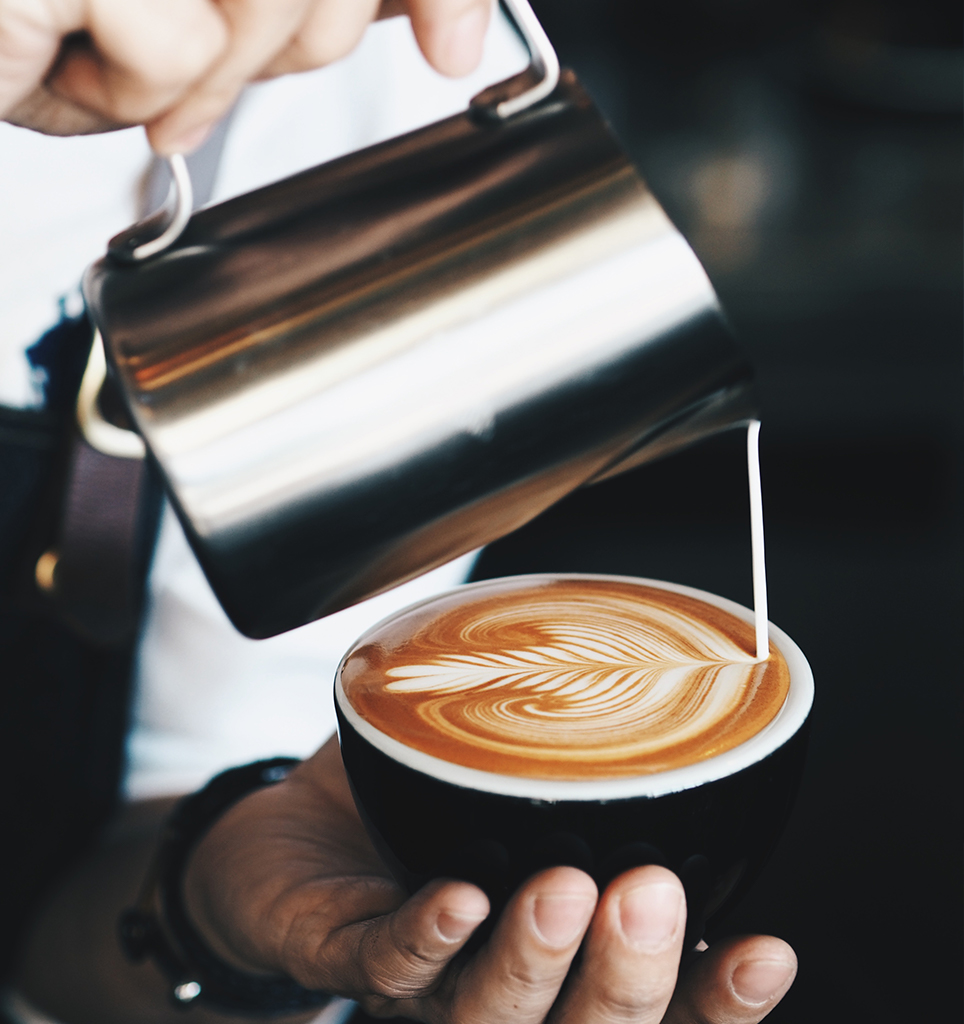 Barista pouring milk for top-notch latte art.